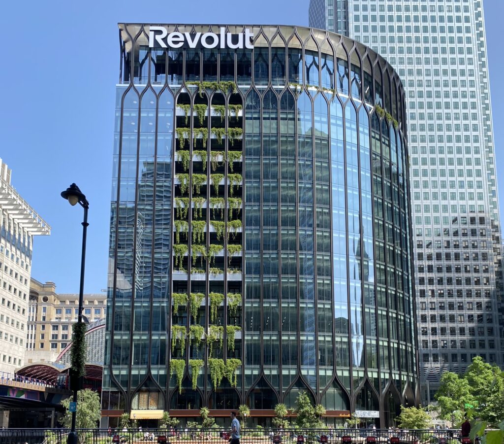 Revolut's office tower at Canary Wharf, London, with a large Revolut sign on the building facade.
