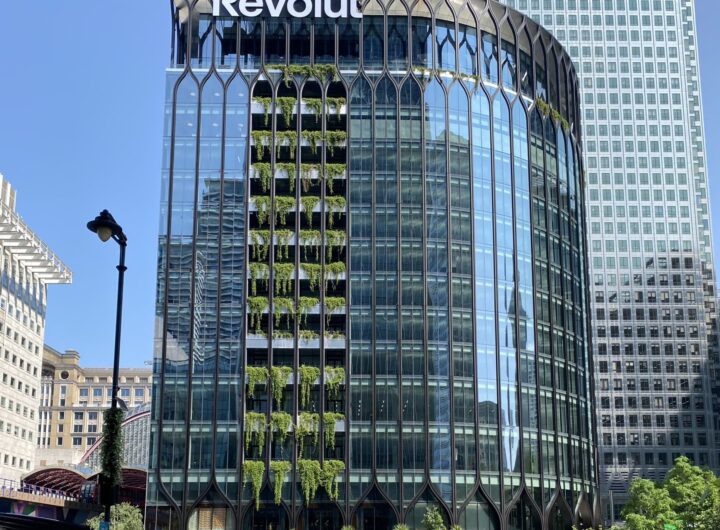 Revolut's office tower at Canary Wharf, London, with a large Revolut sign on the building facade.